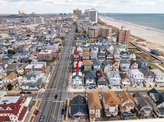 drone / aerial view featuring a view of the beach and a water view