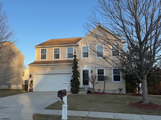 view of front facade featuring a front lawn, a garage, and driveway