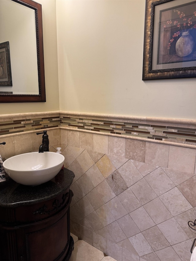 bathroom with a wainscoted wall and vanity