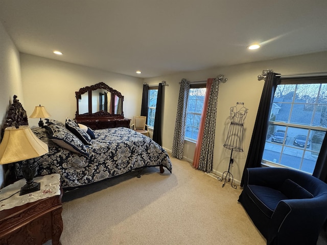 bedroom featuring multiple windows, recessed lighting, and light carpet