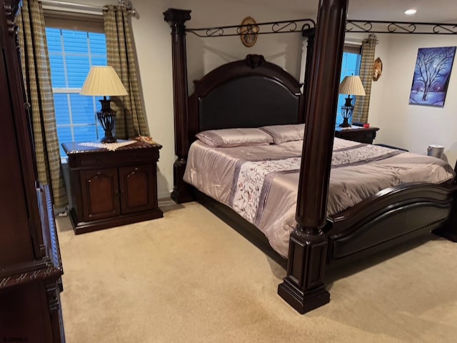 bedroom featuring light carpet