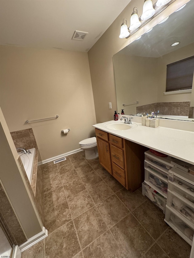 full bathroom with visible vents, toilet, vanity, and a bathtub