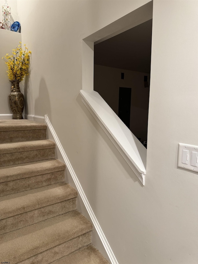 stairway featuring baseboards