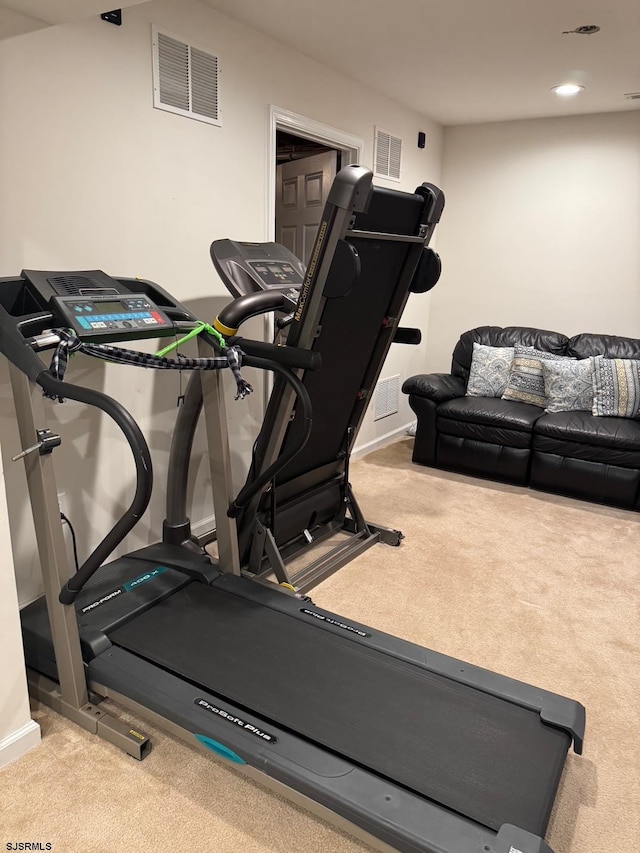 exercise room featuring visible vents, baseboards, and carpet