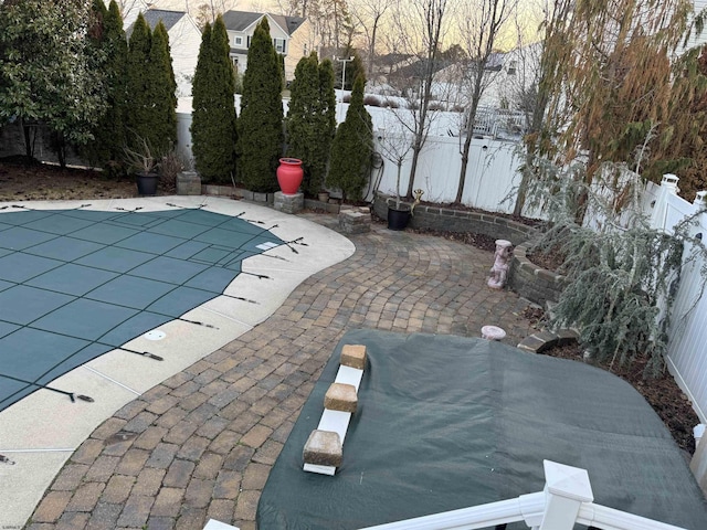 view of swimming pool featuring a fenced in pool, a fenced backyard, and a patio area