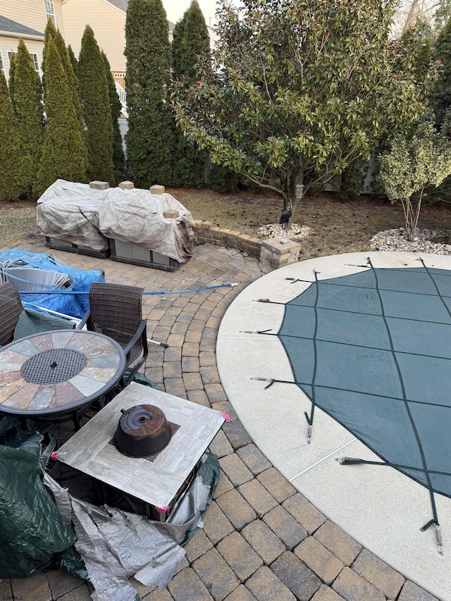 view of swimming pool with a patio