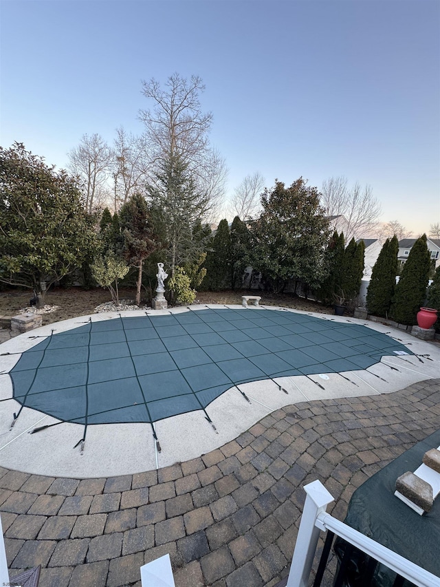 view of pool with a covered pool and a patio area