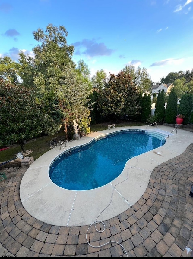 outdoor pool with a patio