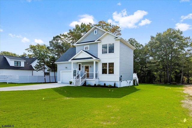 view of front of home with a garage, concrete driveway, a front yard, and fence