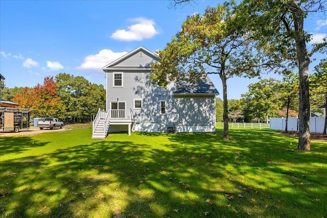 back of house with a yard and fence