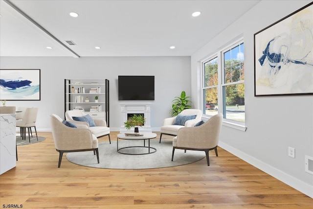 sitting room featuring recessed lighting, a fireplace, visible vents, and light wood finished floors