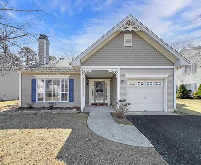 view of front of house with aphalt driveway and an attached garage