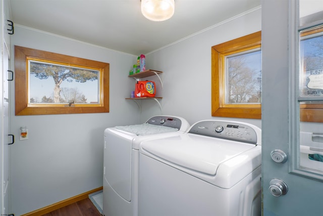 laundry area featuring dark wood-style floors, baseboards, laundry area, ornamental molding, and washer and dryer