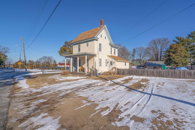 exterior space with a chimney and fence