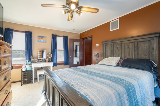 bedroom with visible vents, light carpet, multiple windows, ornamental molding, and ceiling fan