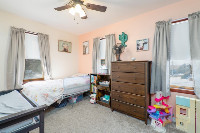 bedroom featuring multiple windows, carpet, and ceiling fan