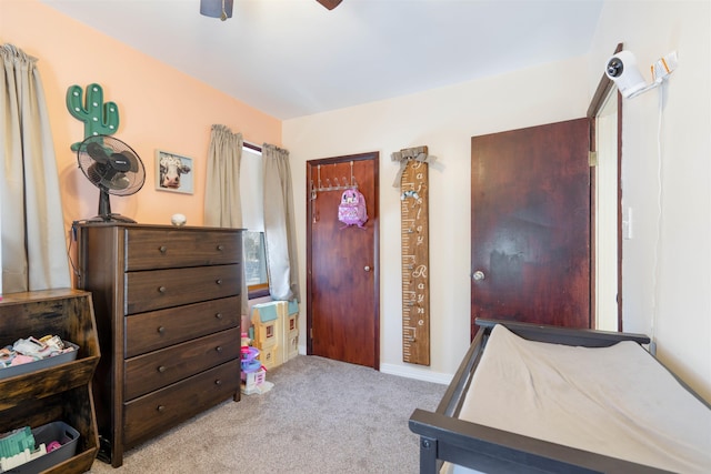 bedroom with a ceiling fan and carpet flooring