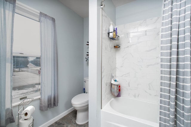 bathroom with toilet, baseboards, and shower / bathtub combination with curtain