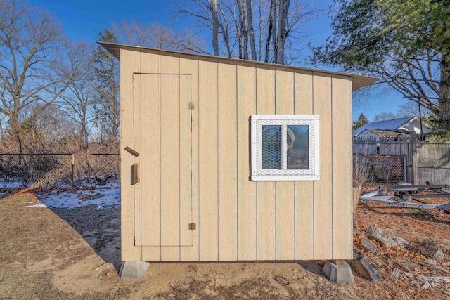 view of shed with fence