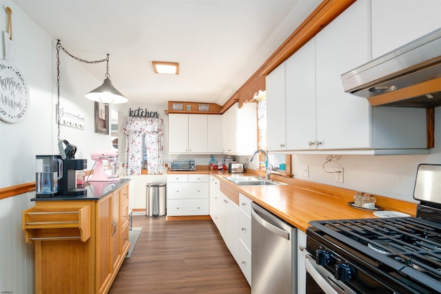 kitchen with a sink, stainless steel appliances, white cabinets, extractor fan, and dark wood-style flooring