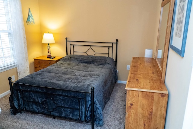 bedroom with baseboards and carpet