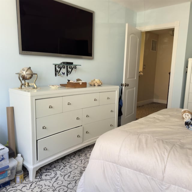 bedroom featuring baseboards and visible vents