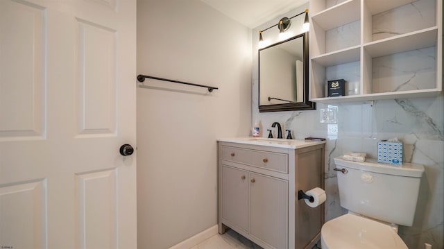 bathroom with decorative backsplash, toilet, and vanity