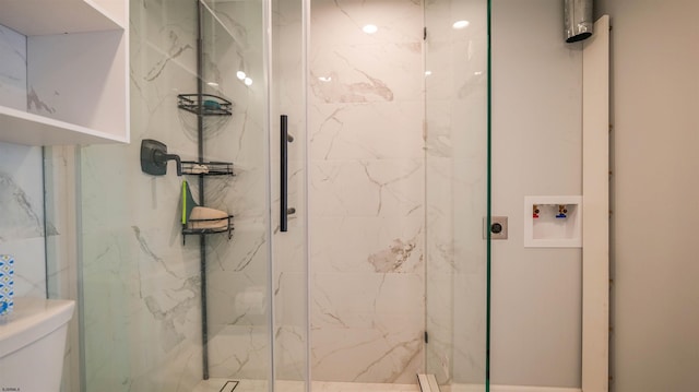 full bathroom featuring a marble finish shower and toilet