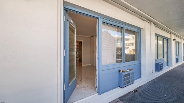 view of exterior entry with stucco siding