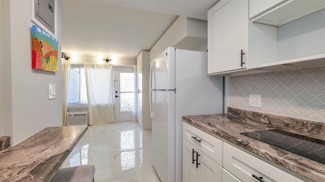 kitchen with freestanding refrigerator, white cabinets, marble finish floor, a wall mounted air conditioner, and tasteful backsplash