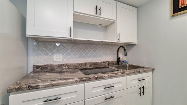 kitchen featuring white cabinetry, open shelves, tasteful backsplash, and a sink