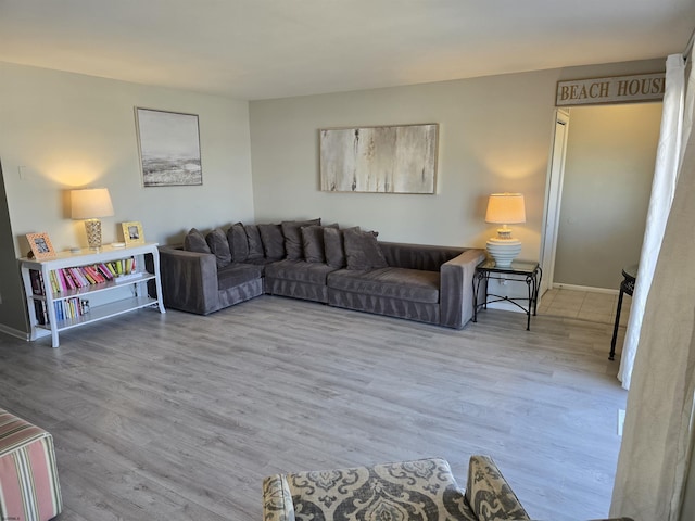 living area with wood finished floors and baseboards