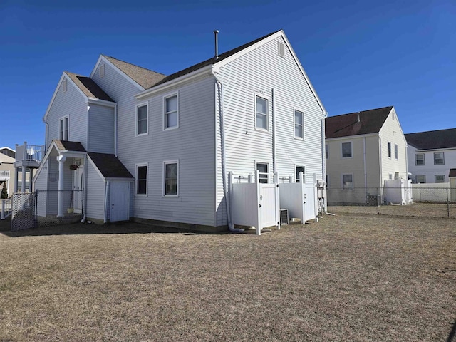 rear view of house with fence