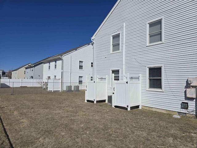 back of house with cooling unit and fence