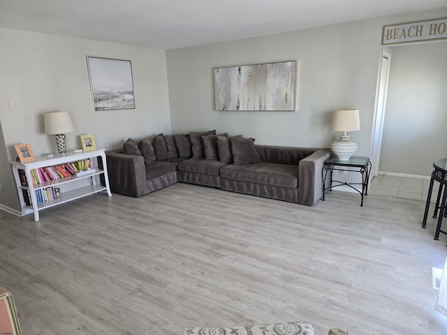 living room featuring baseboards and wood finished floors