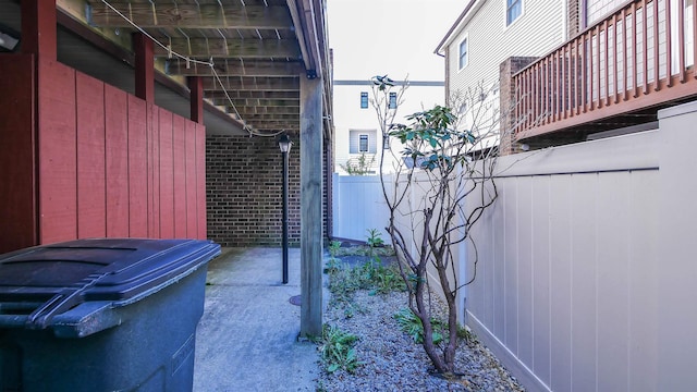 exterior space featuring brick siding and fence