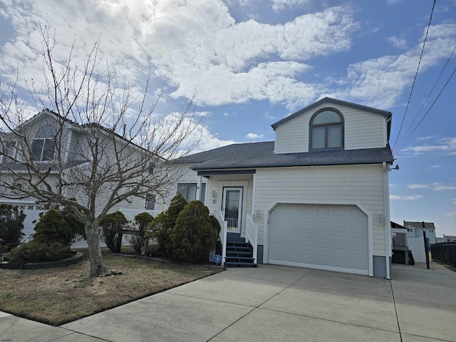 view of front of home with concrete driveway and an attached garage