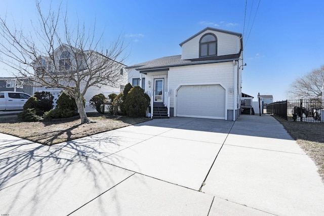18 Macdonald Pl, Brigantine, NJ 08203 - view of front facade with driveway, a garage, and fence