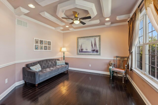 sitting room with hardwood / wood-style flooring, baseboards, visible vents, and ornamental molding