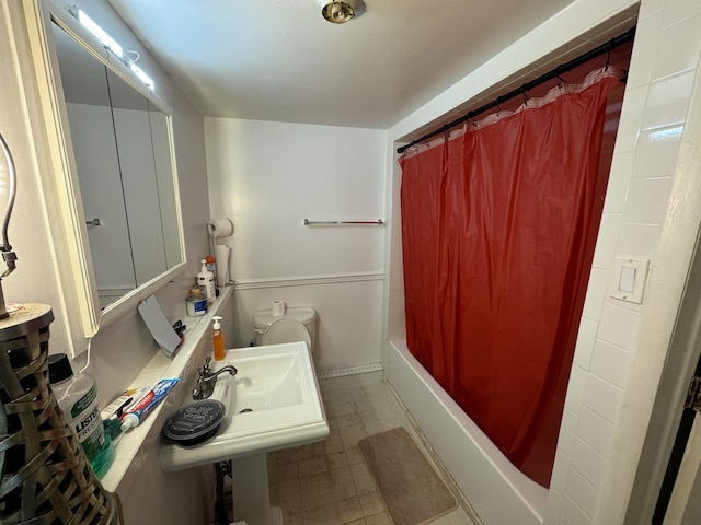 bathroom featuring a sink, shower / bath combo, and tile patterned flooring