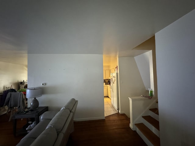 corridor featuring stairway and light wood-style floors