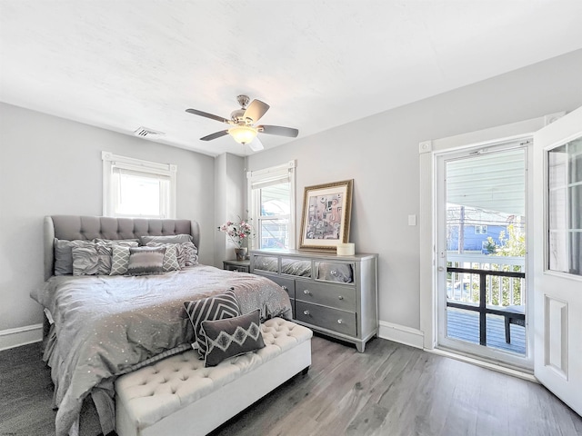 bedroom featuring access to exterior, visible vents, ceiling fan, baseboards, and wood finished floors