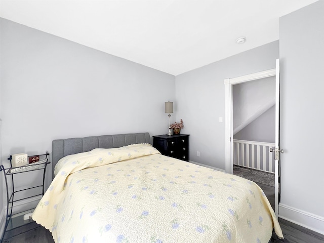 bedroom featuring baseboards and wood finished floors