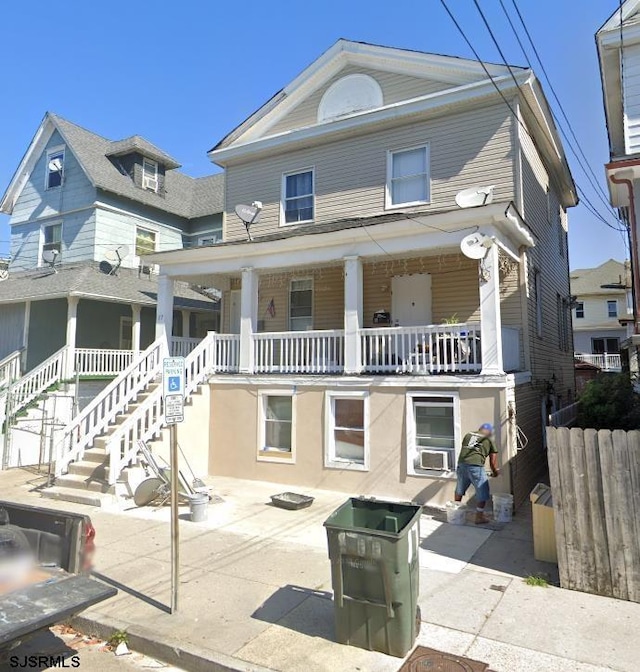 view of front of property with a porch, stairway, and cooling unit