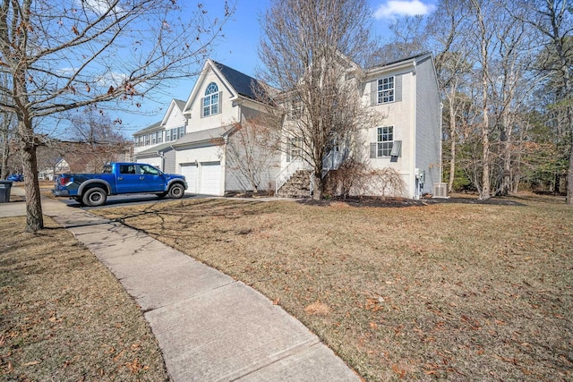 view of home's exterior featuring a lawn, central AC, a garage, and stucco siding