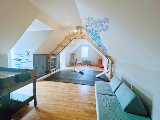 bonus room featuring lofted ceiling and wood finished floors