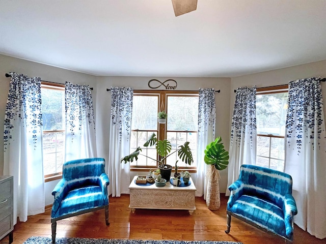 living area with wood finished floors and a healthy amount of sunlight