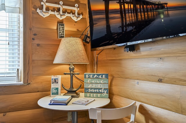 dining space featuring wood walls