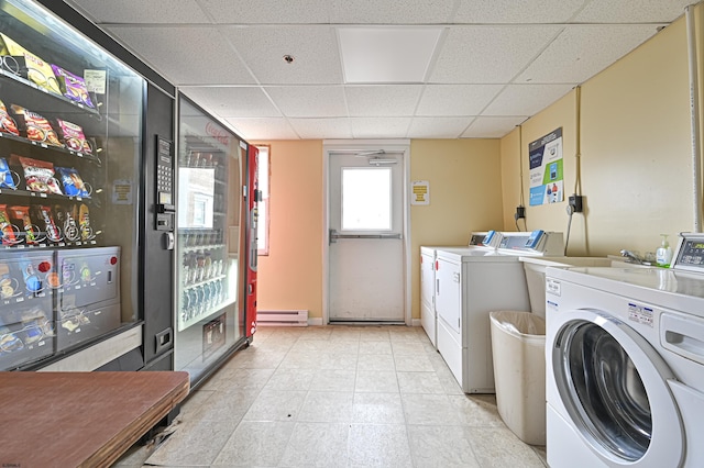 common laundry area featuring washer and dryer, light tile patterned flooring, and baseboard heating