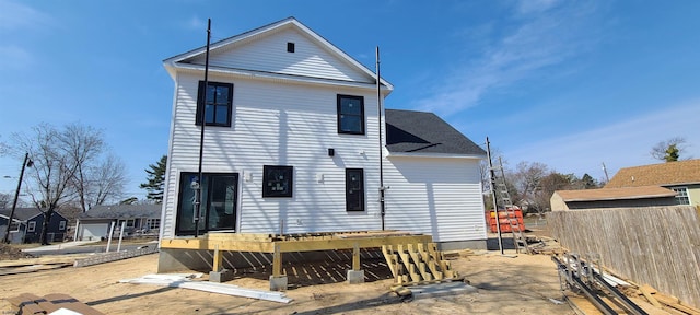 back of house featuring fence